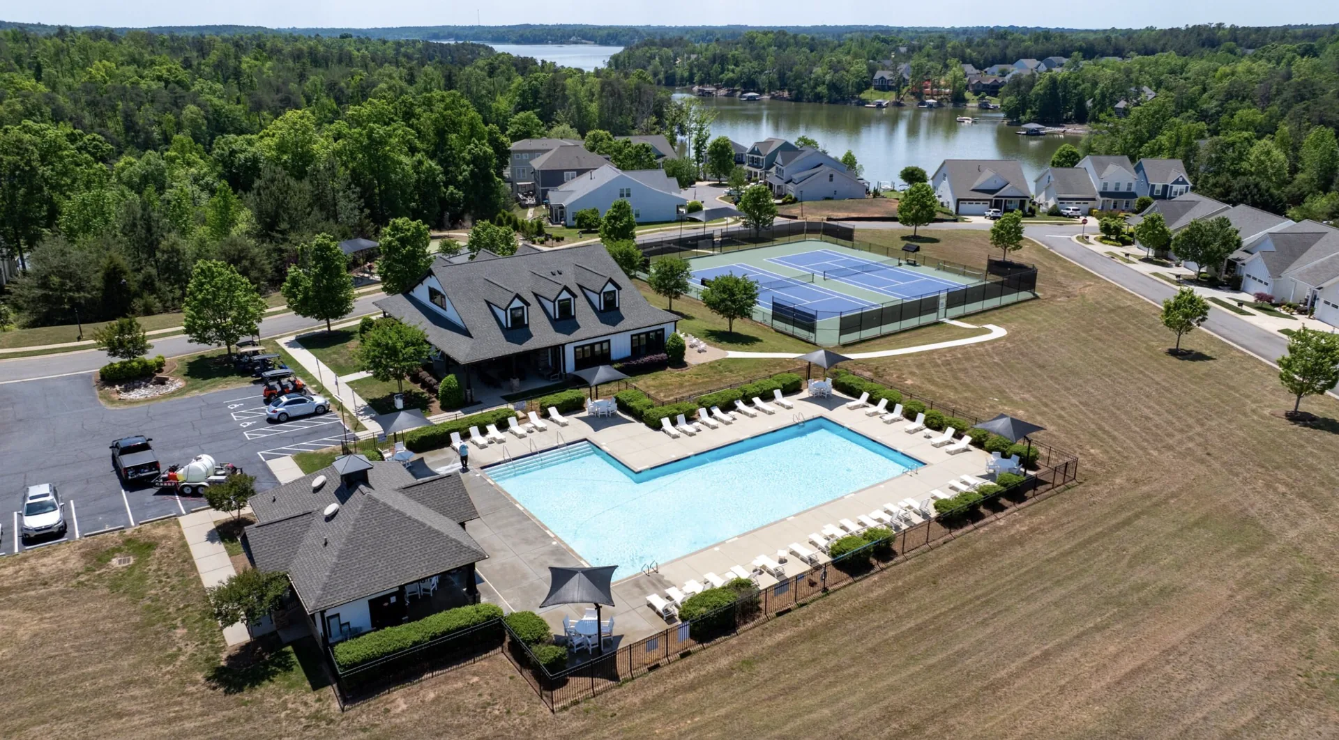 Resort-style pool and tennis courts at The Cottages with lake backdrop