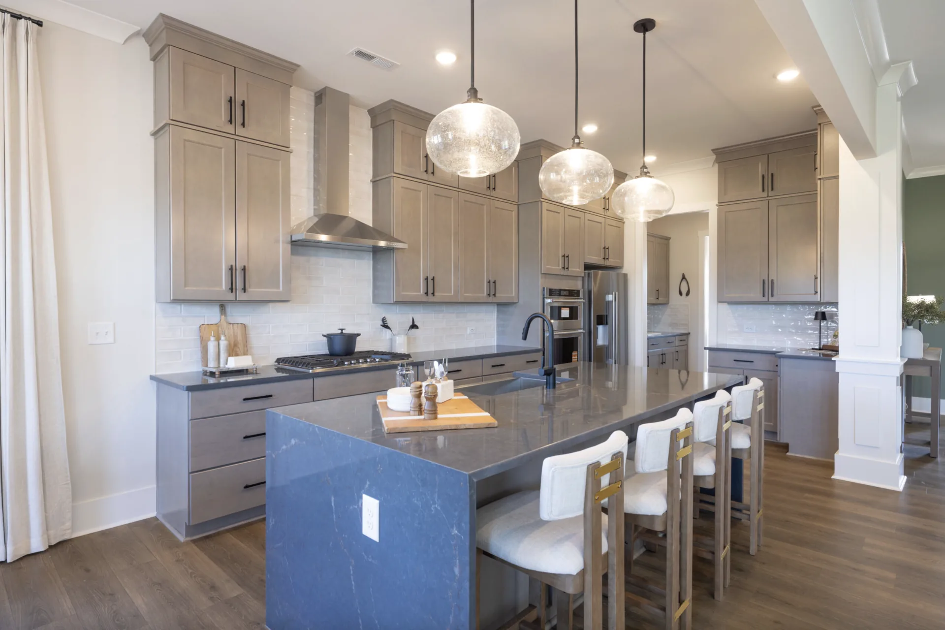 Kitchen with waterfall island in the Winslow